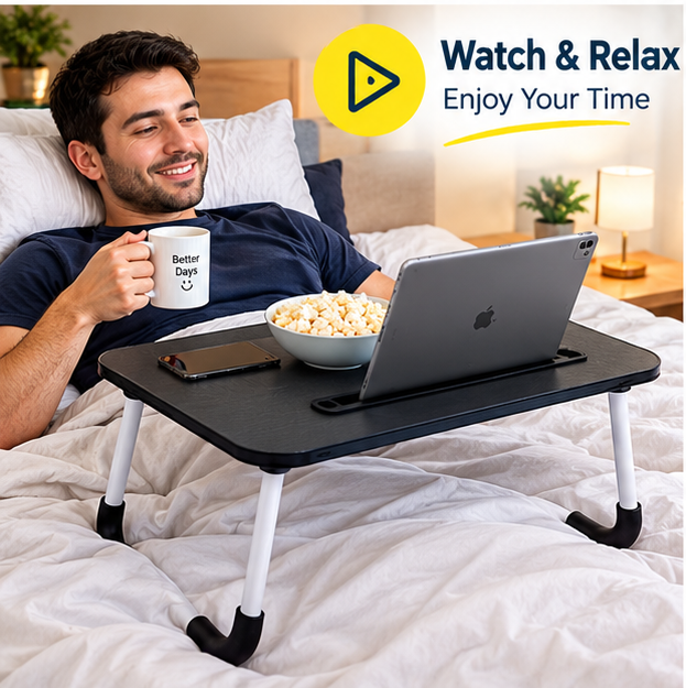  Man relaxing in bed while using portable table for watching videos and entertainment