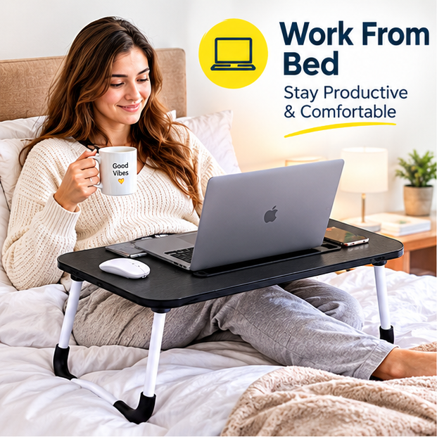  Woman using portable bed table with laptop while working comfortably from bed